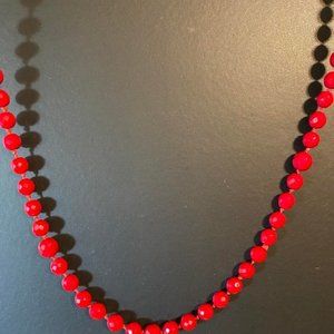 STRING OF GLASS RED BEADS